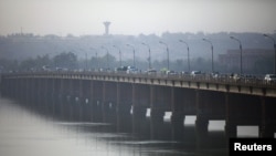 Vehicles cross on a bridge in the Malian capital of Bamako, January 12, 2013.