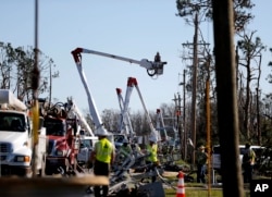 Crews work to restore power in the aftermath of Hurricane Michael in Panama City, Fla., Oct. 13, 2018.