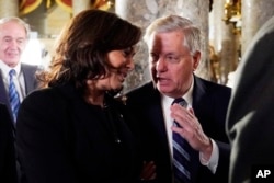 Sen. Kamala Harris, D-Calif and Sen. Lindsey Graham, R-S.C. talk as they arrive to listen to President Donald Trump deliver his State of the Union address to a joint session of Congress on Capitol Hill in Washington, Tuesday, Feb. 5, 2019.