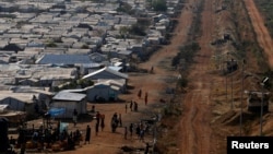 FILE - Internally displaced people gather by a water collection point in a United Nations Mission in South Sudan (UNMISS) Protection of Civilian site (PoC), outside the capital Juba, South Sudan, Jan. 25, 2017.