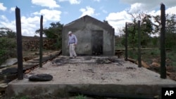 Farmer Martin Evans inspects a blackened home, burned down during an invasion by semi-nomadic herders on his property in Laikipia, Kenya, July 27, 2017.