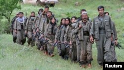 Kurdistan Workers Party (PKK) fighters walk on the way to their new base in northern Iraq, May 14, 2013.