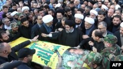 Lebanese Shiite cleric and senior Hezbollah offical Hashim Safi al-Din, center, stands with fellow mourners during a funeral procession in a southern suburb of the Lebanese capital Beirut, Dec. 21, 2015.