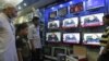 People watch Prime Minister of Pakistan Nawaz Sharif addressing the nation, at an electronic shop in Karachi, Aug. 19, 2013. 