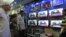 People watch Prime Minister of Pakistan Nawaz Sharif addressing the nation, at an electronic shop in Karachi, Aug. 19, 2013. 