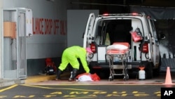 A paramedic sanitizes an ambulance at the Christiaan Barnard Memorial Hospital in Cape Town, South Africa, July 10, 2020. The Africa Centers for Disease Control and Prevention says the coronavirus pandemic on the continent is reaching "full speed."