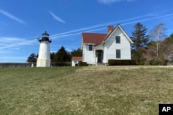 Warwick Neck Light, that dates to 1827 and was a onetime important navigation tool for mariners making their way to Providence, R.I., stands near Narragansett Bay, April 12, 2023, in Warwick, R.I. (Barbara Salfity/General Services Administration via AP)