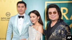 Henry Golding, from left, Constance Wu and executive producer/author Kevin Kwon arrive at the premiere of "Crazy Rich Asians" at the TCL Chinese Theatre, Aug. 7, 2018, in Los Angeles, California.