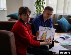 Nataliya and Volodymyr Babeush attend an interview with Reuters in Zaporizhzhia