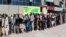 Afghans wait in front of Kabul Bank, in Kabul, Afghanistan, Wednesday, Aug. 25.2021. The Taliban wrested back control of Afghanistan nearly 20 years after they were ousted in a U.S.-led invasion following the 9/11 attacks. Their return to power has…