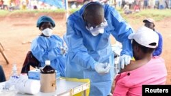 FILE - A Congolese health worker administers Ebola vaccine to a woman who had contact with an Ebola sufferer in the Democratic Republic of Congo, Aug. 18, 2018. 