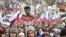 Demonstrators, with Russian flags and a portrait of Boris Nemtsov with the words reading "Do not lie, do not steal", march in memory of opposition leader Boris Nemtsov in Moscow, Russia, Sunday, Feb. 24, 2019.