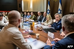 This photo released by the Israeli Government Press Office shows Prime Minister Benjamin Netanyahu, fifth from right, heading a security Cabinet meeting to vote on a Gaza ceasefire and hostage release deal, in Jerusalem on Jan. 17, 2025.