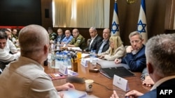 This handout picture released by the Israeli Government Press Office (GPO) shows Prime Minister Benjamin Netanyahu (5-R), heading a security Cabinet meeting to vote on a Gaza ceasefire and hostage release deal, in Jerusalem, Jan. 17, 2025.