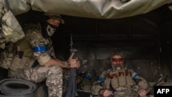 Ukrainian servicemen wait in a military vehicle to head for a combat mission, in the Sumy region, near the border with Russia, on August 13, 2024, amid the Russian invasion of Ukraine.