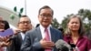 FILE - Cambodia's exiled opposition leader Sam Rainsy, left, speaks to the media as he arrived at Kuala Lumpur International's Airport in Sepang, Malaysia, Nov. 9, 2019. 