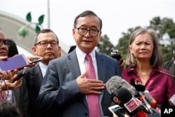 FILE - Cambodia's exiled opposition leader Sam Rainsy talks to the media outside Parliament House in Kuala Lumpur, Malaysia, Nov. 12, 2019.