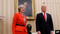 President Donald Trump stands with British Prime Minister Theresa May in the Oval Office of the White House in Washington, Jan. 27, 2017.