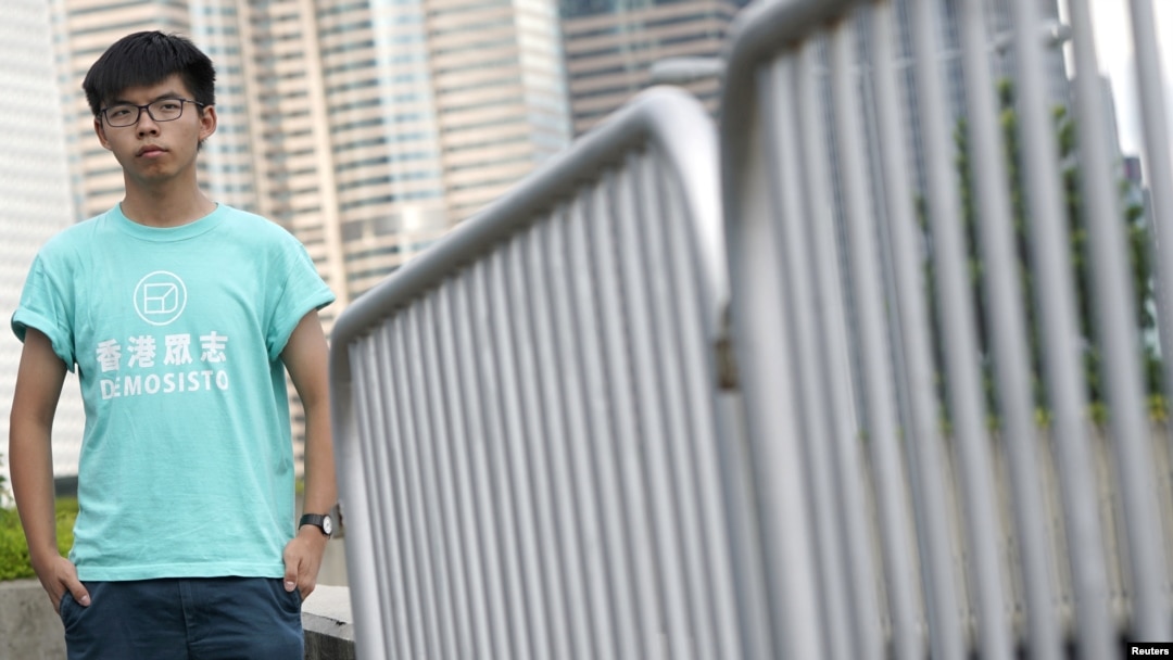 FILE - Hong Kong student leader Joshua Wong poses for a photo, a day before an appeal verdict on charges relating to 2014 pro-democracy "Umbrella Movement," also known as "Occupy Central" protests, in Hong Kong, Aug. 15, 2017.