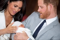 FILE - Britain's Prince Harry and Meghan, Duchess of Sussex hold their baby son during a photocall in St George's Hall at Windsor Castle, in Berkshire, Britain May 8, 2019.