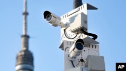 (FILE) Surveillance cameras sit on a utility pole in Moscow, Russia.