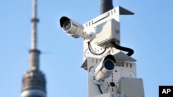 FILE - Surveillance cameras sit on a utility pole in Moscow, Russia on February 22, 2020. (AP Photo, File)