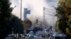 Smoke rises as emergency rescue teams and police officers attend outside Turkish Aerospace Industries Inc. on the outskirts of Ankara, Oct. 23, 2024. 