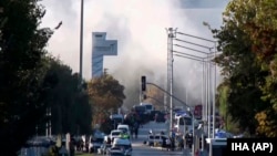 Smoke rises as emergency rescue teams and police officers attend outside Turkish Aerospace Industries Inc. on the outskirts of Ankara, Oct. 23, 2024. 