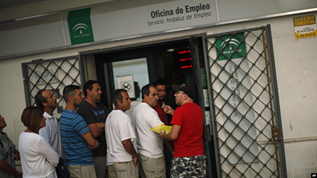 A man offers his queue ticket as people wait in line to enter a government job center in Marbella, Spain, September 2, 2011.
