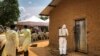 FILE - A worker from the World Health Organization decontaminates the doorway of a house in the village of Mabalako, in eastern Congo, June 17, 2019. 