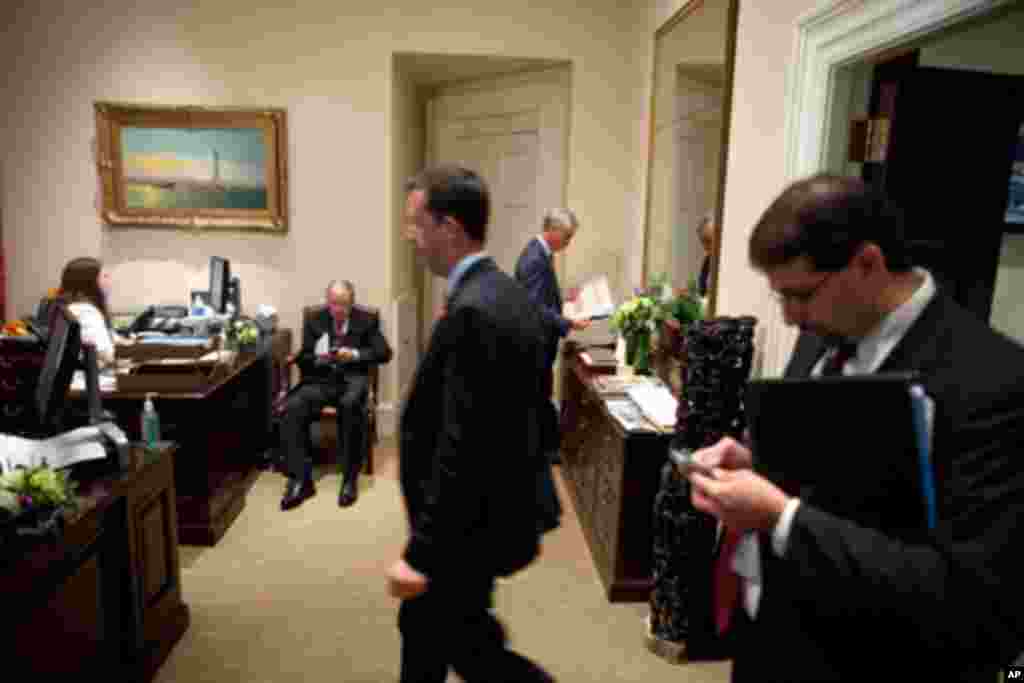 Libyan voters line up at a polling station in Benghazi, July 7, 2012. Jubilant Libyans marked a major step toward democracy after decades of rule by&nbsp;dictator Moammar Gadhafi. "Don't forget the blood of the martyrs" is in Arabic at left.