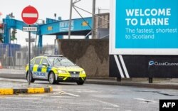 A police vehicle patrols after threats were made to port workers implementing post-Brexit trade checks in Northern Ireland, at the Port of Larne in County Antrim, Feb. 2, 2021.