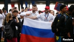 Russia athletes pose with their national flag during the opening ceremony for the Alba Games in Macuto, Venezuela, April 21, 2023.