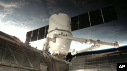 This frame grab made available by NASA TV shows a view of the SpaceX Dragon anchoring to the International Space Station, March 3, 2013.