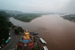 FILE - A giant Buddha on the Thai side of the Golden Triangle in Chiang Rai province, is seen with Myanmar in the background and Laos on the right, Sept. 20, 2019.