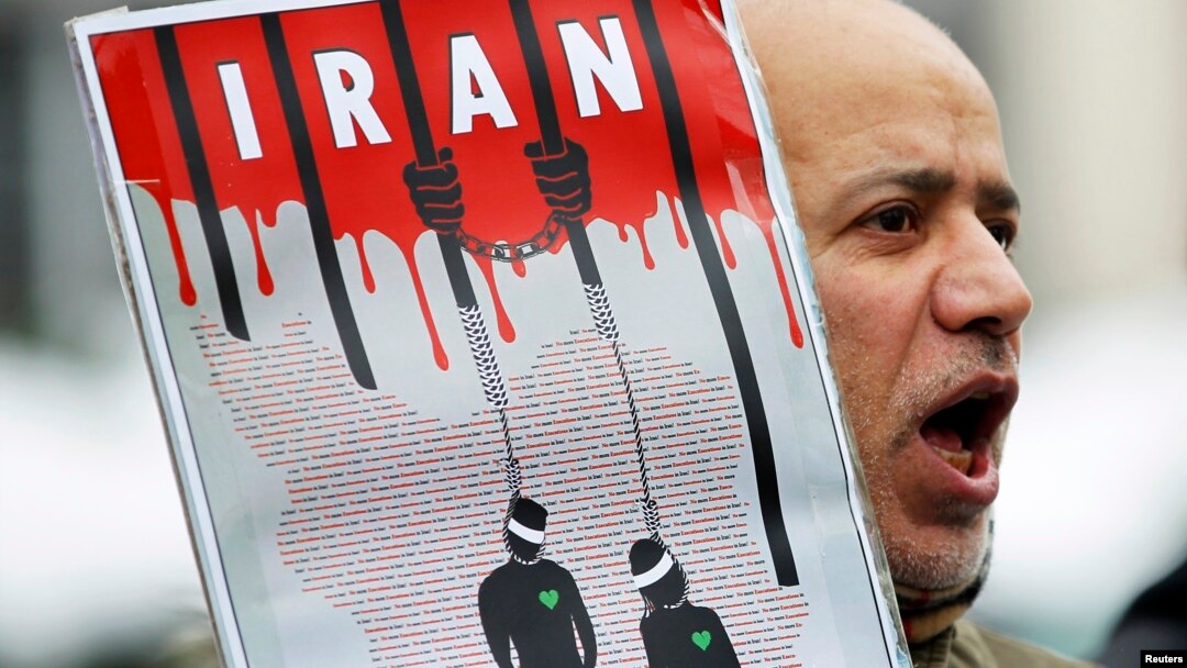 FILE - An Iranian exile shouts slogans to protest against executions in Iran during a demonstration in front of the Iranian embassy in Brussels on December 29, 2010.