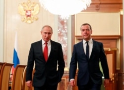 Russian President Vladimir Putin, left, and Russian Prime Minister Dmitry Medvedev walk prior to a cabinet meeting in Moscow, Russia, Jan. 15, 2020.