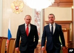 Russian President Vladimir Putin, left, and Russian Prime Minister Dmitry Medvedev walk prior to a cabinet meeting in Moscow, Russia, Jan. 15, 2020.