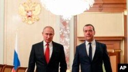 Russian President Vladimir Putin, left, and Russian Prime Minister Dmitry Medvedev walk prior to a cabinet meeting in Moscow, Russia, Jan. 15, 2020. 