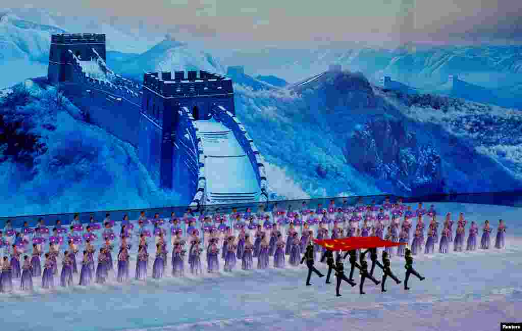 Members of the Chinese military march with a flag of China during the opening ceremony of the Asian Winter Games in Harbin, China.