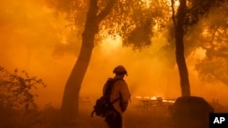 A firefighter battles the Airport Fire in El Cariso, an unincorporated community in Riverside County, California, Sept. 10, 2024.