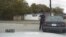 In this April 4, 2015, frame from dashboard video provided by the North Charleston Police Department, Patrolman Michael Thomas Slager stands by Walter Lamer Scott's car during a traffic stop in North Charleston, S.C. 