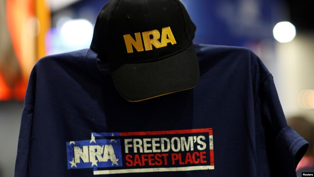 FILE - A cap and shirt are displayed at the booth for the National Rifle Association (NRA) at the Conservative Political Action Conference (CPAC) at National Harbor, Maryland, U.S., Feb. 23, 2018. 
