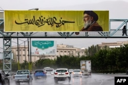 A banner bearing a representation   of Lebanon's Hezbollah person  Hassan Nasrallah with penning  successful  Farsi that reads "Hezbollah is alive" hangs on  a span  successful  bluish   Tehran, Iran, connected  Sept. 28, 2024.