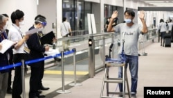 Japanese journalist Yuki Kitazumi who was detained in Myanmar and charged with spreading false news during a crackdown on media after a military coup in Feb., speaks to media upon his arrival at Narita Airport in Narita, Japan, May 14, 2021. (Kyodo photo)