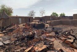 FILE - A general view shows the damage at the site of an attack on a village in Mali, June 11, 2019.