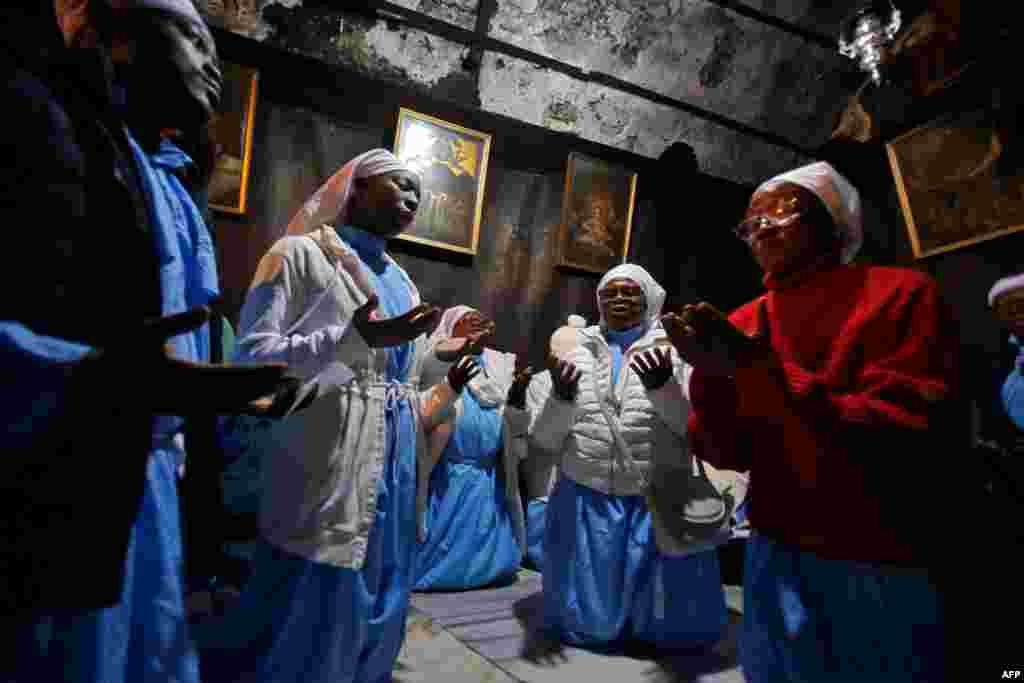 Christian pilgrims pray in the Grotto of the Church of the Nativity on Christmas Eve in the biblical West Bank city of Bethlehem.