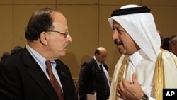 Libyan Finance Minister Nagib Mustafa al-Serraj, left, talks with Yousef Hussain Kamal, Qatar Finance Minister, at the opening of Arab Finance Ministers Exceptional meeting in Abu Dhabi, United Arab Emirates, September 7, 2011.