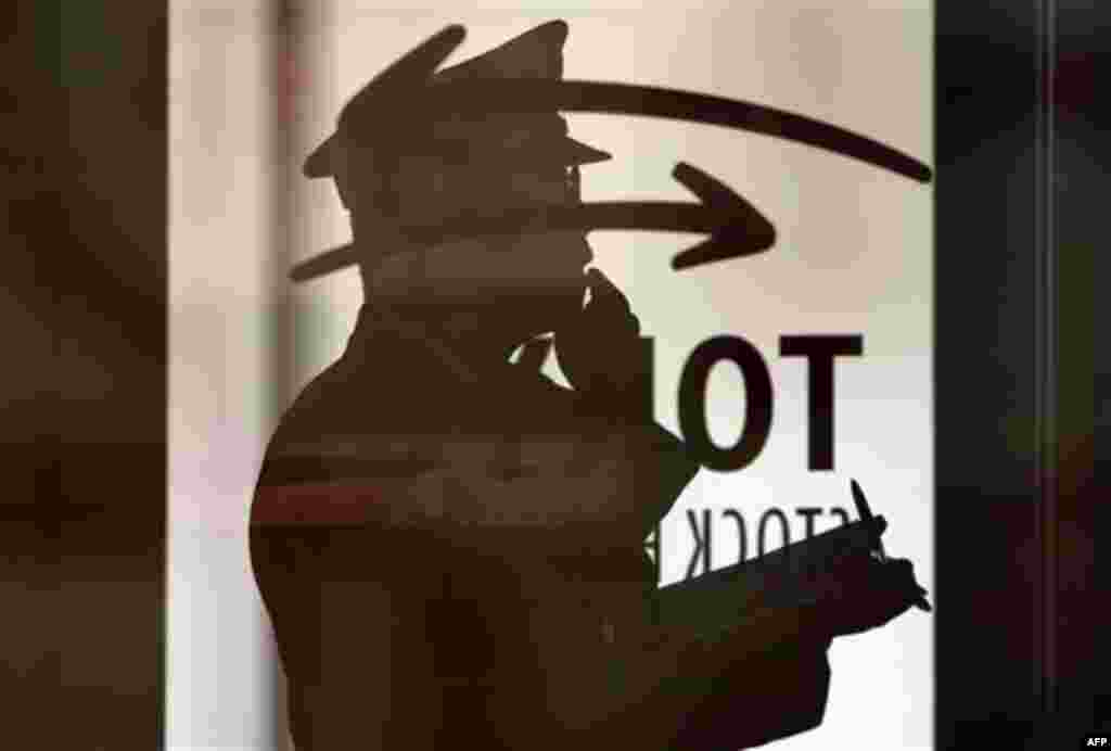 A security guard mans at the Tokyo Stock Exchange in Tokyo, Friday Feb. 24, 2012. Asian stocks markets mostly posted tentative gains Friday following a mixed bag of U.S. and European economic reports and as oil prices rose to a new nine-month high. Japan'