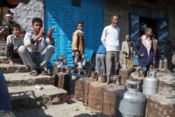 FILE - People wait to refill their gas cylinders amid increasing shortages in Yemen's third city of Taez, July 31, 2021.